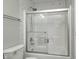Shower with a sliding glass door, white marble-look tile, and modern fixtures at 4644 Shelby Cir, Greenwood, IN 46143