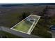 Aerial view of a single Gathering home on a large lot, outlined in white with a gravel driveway leading to the street at 4653 E Us Highway 36, Markleville, IN 46056