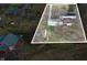 An aerial of a home and garage on a large property, surrounded by other properties and bare trees at 4653 E Us Highway 36, Markleville, IN 46056