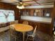 Charming dining area featuring a round table, wood cabinets, and a decorative ceiling fan at 4653 E Us Highway 36, Markleville, IN 46056