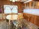 Cozy dining area with wood accents, complemented by a round table and classic cabinets at 4653 E Us Highway 36, Markleville, IN 46056