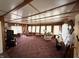 Spacious living room with beamed ceilings, multiple windows, and vintage decor at 4653 E Us Highway 36, Markleville, IN 46056
