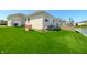 Spacious backyard with a lush lawn, mature trees, pond access, and an outdoor play area at 4858 Brentridge Pl, Greenwood, IN 46143
