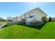 Beautiful backyard with a serene pond view, lush lawn, mature trees, and a spacious deck at 4858 Brentridge Pl, Greenwood, IN 46143