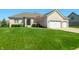 Charming brick home featuring a manicured lawn, arched entryway, and attached three-car garage at 4858 Brentridge Pl, Greenwood, IN 46143