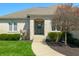 Charming home featuring a decorative front door, manicured lawn, and mature landscaping at 4858 Brentridge Pl, Greenwood, IN 46143
