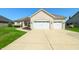 This home features a three-car garage and a well-maintained yard at 4858 Brentridge Pl, Greenwood, IN 46143
