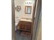 This bathroom has a wood vanity, dark vinyl floor, and a mirror on the wall at 4902 N 700 W, McCordsville, IN 46055