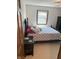 Charming bedroom featuring a dark bed frame, patterned bedding, and side table at 4902 N 700 W, McCordsville, IN 46055