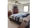 Comfortable bedroom with blue striped bedding, dresser, and natural light at 4902 N 700 W, McCordsville, IN 46055