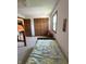 Bright bedroom with a twin bed, wood closet doors, and a bright window at 4902 N 700 W, McCordsville, IN 46055