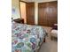 Bright bedroom featuring a patterned bedspread, seating, and closet doors at 4902 N 700 W, McCordsville, IN 46055