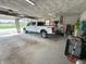 Well-lit garage featuring a white pickup truck, offering ample parking and storage space at 4902 N 700 W, McCordsville, IN 46055