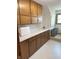 The laundry room has ample storage space with wooden cabinets and a white countertop at 4902 N 700 W, McCordsville, IN 46055