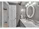 This bathroom features a modern vanity with a marble countertop and brushed nickel hardware at 4930 Founders Ct, Anderson, IN 46017