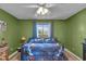 The bedroom features light-green walls, and a sunny window view at 4930 Founders Ct, Anderson, IN 46017