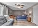 Cozy bedroom features a ceiling fan, wood floors, and a comfortable seating area at 4930 Founders Ct, Anderson, IN 46017