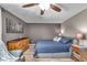 Comfortable bedroom with a blue quilted bed, wood-look flooring, and stylish decor at 4930 Founders Ct, Anderson, IN 46017