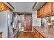 Spacious kitchen with stainless steel refrigerator, barn door, and wooden cabinets at 4930 Founders Ct, Anderson, IN 46017