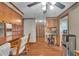 Open kitchen layout with breakfast bar, wood floors, and a view into a hallway with a built-in desk at 4930 Founders Ct, Anderson, IN 46017