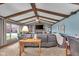 Inviting living room with exposed beams, brick fireplace, and comfortable gray sofa at 4930 Founders Ct, Anderson, IN 46017