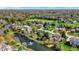 Picturesque aerial view of a neighborhood featuring well-manicured lawns, mature trees, and a serene pond with a fountain at 4932 Willow Ridge Ct, Zionsville, IN 46077