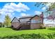 Beautifully landscaped backyard with a home featuring a brick exterior and a charming deck area for outdoor enjoyment at 4932 Willow Ridge Ct, Zionsville, IN 46077