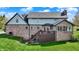 Rear exterior of a well-maintained home featuring a brick facade, spacious backyard, and a private deck at 4932 Willow Ridge Ct, Zionsville, IN 46077