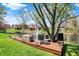Expansive backyard featuring a wooden deck with lounge seating, perfect for relaxing by the calm pond at 4932 Willow Ridge Ct, Zionsville, IN 46077