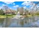 A picturesque backyard with a serene pond and fountain creating a relaxing retreat at 4932 Willow Ridge Ct, Zionsville, IN 46077