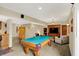 Spacious finished basement with a pool table, seating area, and built in entertainment center at 4932 Willow Ridge Ct, Zionsville, IN 46077