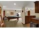 Large finished basement featuring a pool table, wet bar, and sliding doors to the outside at 4932 Willow Ridge Ct, Zionsville, IN 46077