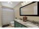 Bathroom featuring dual sinks, granite countertop, shower, and a large mirror at 4932 Willow Ridge Ct, Zionsville, IN 46077