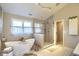 Beautiful bathroom featuring a freestanding tub, a separate glass-enclosed shower, and neutral tiling at 4932 Willow Ridge Ct, Zionsville, IN 46077