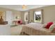 Neutral bedroom with two windows, pink accents, carpet, and an adjacent desk with accent chair at 4932 Willow Ridge Ct, Zionsville, IN 46077