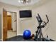 Home exercise room equipped with an elliptical machine, TV and weights at 4932 Willow Ridge Ct, Zionsville, IN 46077