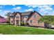 Attractive brick home with a well-manicured lawn and garden beds at 4932 Willow Ridge Ct, Zionsville, IN 46077