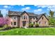 Beautiful two-story brick home with lush green lawn and meticulously maintained landscaping at 4932 Willow Ridge Ct, Zionsville, IN 46077