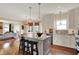 Open-concept kitchen boasts granite counters, stainless appliances, and a center island with seating at 4932 Willow Ridge Ct, Zionsville, IN 46077
