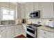 Cozy kitchen featuring granite countertops, stainless steel appliances, and ample cabinet space at 4932 Willow Ridge Ct, Zionsville, IN 46077