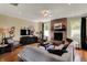 Inviting living room featuring a brick fireplace, hardwood flooring, and neutral color palette at 4932 Willow Ridge Ct, Zionsville, IN 46077