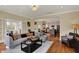 Bright living room with hardwood floors, a comfortable sofa, and access to the kitchen at 4932 Willow Ridge Ct, Zionsville, IN 46077