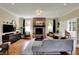 Spacious living room with brick fireplace, hardwood floors, and stylish decor at 4932 Willow Ridge Ct, Zionsville, IN 46077