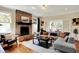 Cozy living room with brick fireplace, hardwood floors, and comfortable seating arrangement at 4932 Willow Ridge Ct, Zionsville, IN 46077