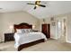 Spacious main bedroom with vaulted ceilings, fan, carpet, and decorative furniture pieces at 4932 Willow Ridge Ct, Zionsville, IN 46077
