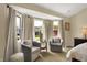 Comfortable seating area in the main bedroom, with lots of natural light through the bay windows at 4932 Willow Ridge Ct, Zionsville, IN 46077