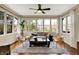 Bright sun room with many windows, hardwood floors, and comfortable seating arrangement at 4932 Willow Ridge Ct, Zionsville, IN 46077