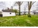Backyard featuring lush green grass and a detached garage at 5140 Indianola Ave, Indianapolis, IN 46205