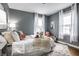 Stylishly decorated bedroom with a plush bed, throw pillows, soft lighting, and cozy ambiance at 5140 Indianola Ave, Indianapolis, IN 46205