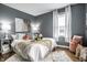 Comfortable bedroom featuring stylish decor, accent pillows, and soft, natural light from the window at 5140 Indianola Ave, Indianapolis, IN 46205